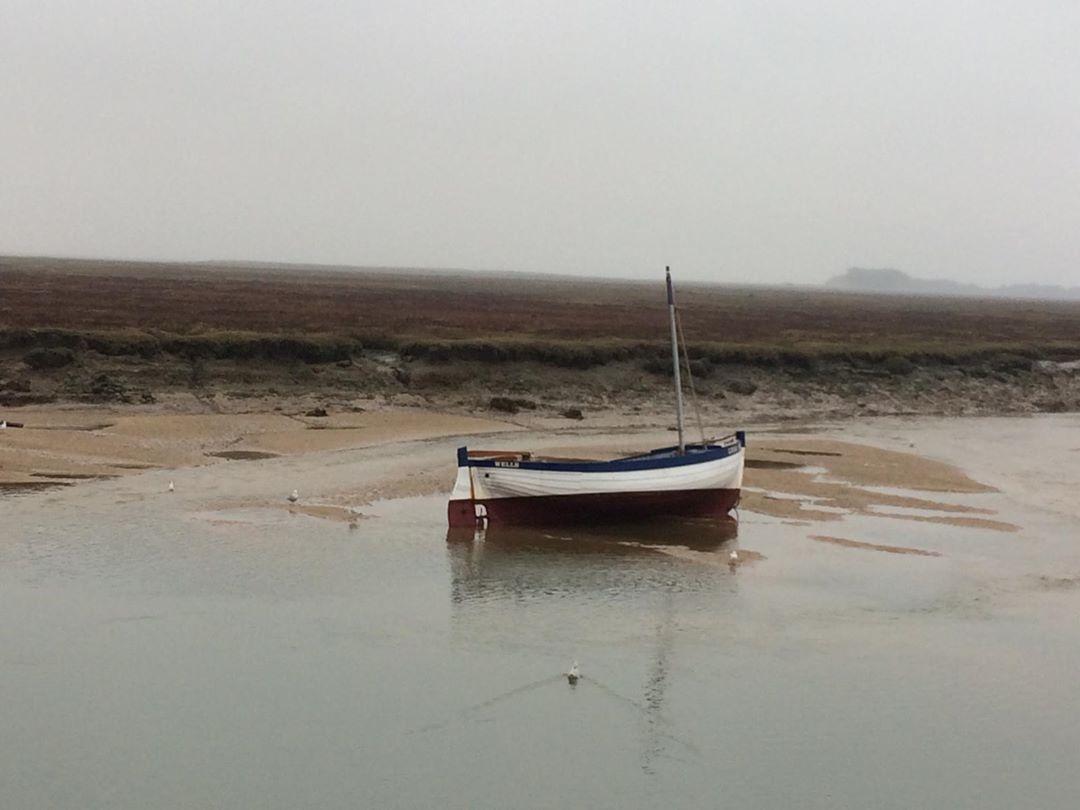 Charl Knitwear A small boat in the sea